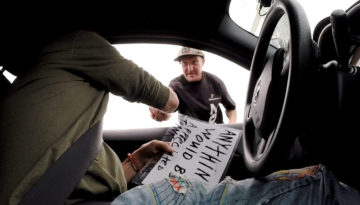 SIGNS OF HUMANITY Willie Baronet buys a sign from Randy in Portland